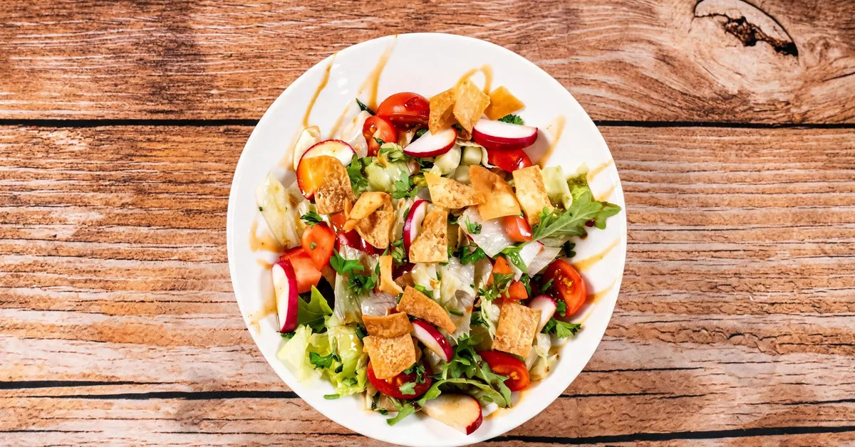 Fattoush salad with crisp pita chips, cherry tomatoes, and radish