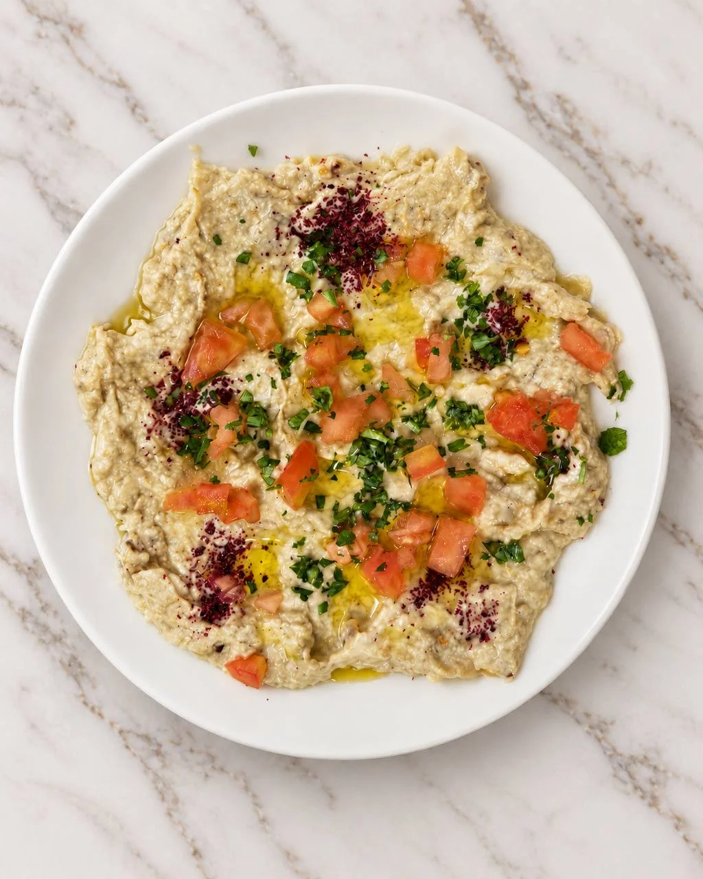 Baba ghanoush with olive oil, tomato, parsley, and sumac