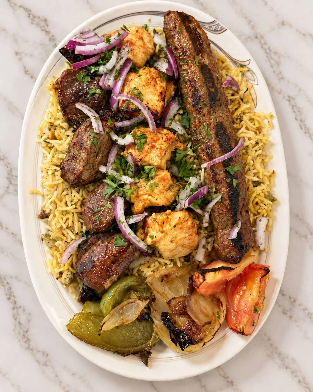 Mixed grill platter with seasoned rice and roasted vegetables